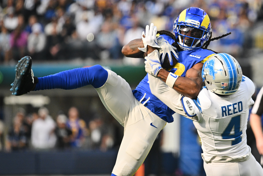 Los Angeles Rams wide receiver Davante Adams (17) makes a catch over Detroit Lions cornerback D.J. Reed (4) during the first half of an NFL football game Sunday, Dec. 14, 2025, in Inglewood, Calif. (AP Photo/Katie Chin)