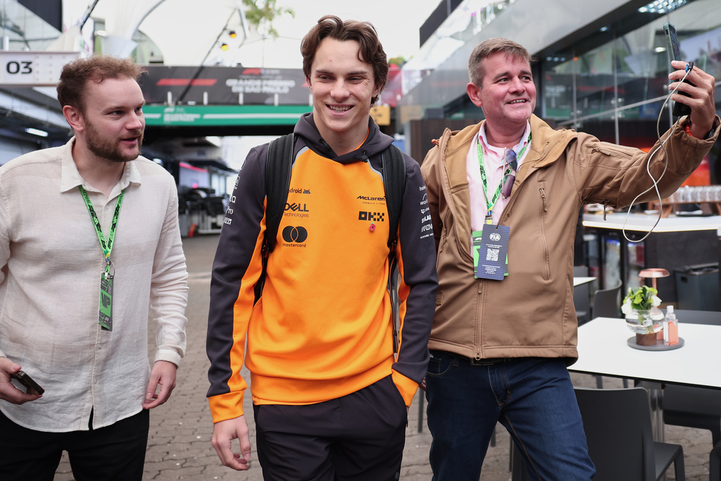 McLaren driver Oscar Piastri of Australia, center, arrives at the Interlagos race track ahead of the Brazilian Formula One Grand Prix in Sao Paulo, Sunday, Nov. 9, 2025. (AP Photo/Ettore Chiereguini)