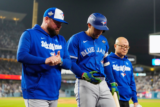 Toronto Blue Jays' George Springer, center, walks off the field as he leaves with an injury with manager John Schneider, left, and first assistant athletic trainer Voon Chong, right, during the seventh inning in Game 3 of baseball's World Series against the Los Angeles Dodgers in Los Angeles, Monday, Oct. 27, 2025. (Frank Gunn/The Canadian Press via AP) Toronto Blue Jays' George Springer, center, walks off the field as he leaves with an injury with manager John Schneider, left, and first assistant athletic trainer Voon Chong, right, during the seventh inning in Game 3 of baseball's World Series against the Los Angeles Dodgers in Los Angeles, Monday, Oct. 27, 2025. (Frank Gunn/The Canadian Press via AP)