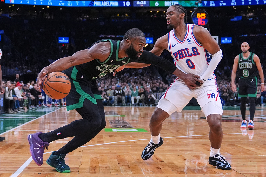 Boston Celtics guard Jaylen Brown, left, drives to the basket against Philadelphia 76ers guard Tyrese Maxey (0) during the first half of Game 5 of a first-round NBA playoffs basketball series, Tuesday, April 28, 2026, in Boston. (AP Photo/Charles Krupa)