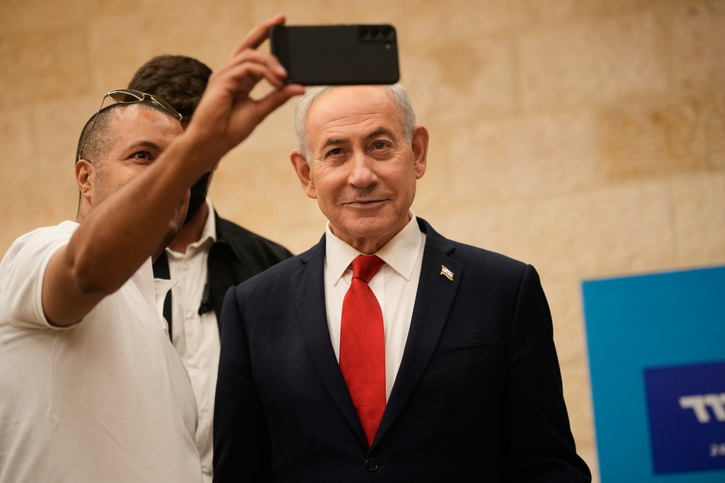 A man takes a selfie with Israeli Prime Minister Benjamin Netanyahu during the Likud party primary elections ahead of Israel's general election in October, in Jerusalem, Monday, Aug. 17, 2026. (AP Photo/Ohad Zwigenberg, Pool)