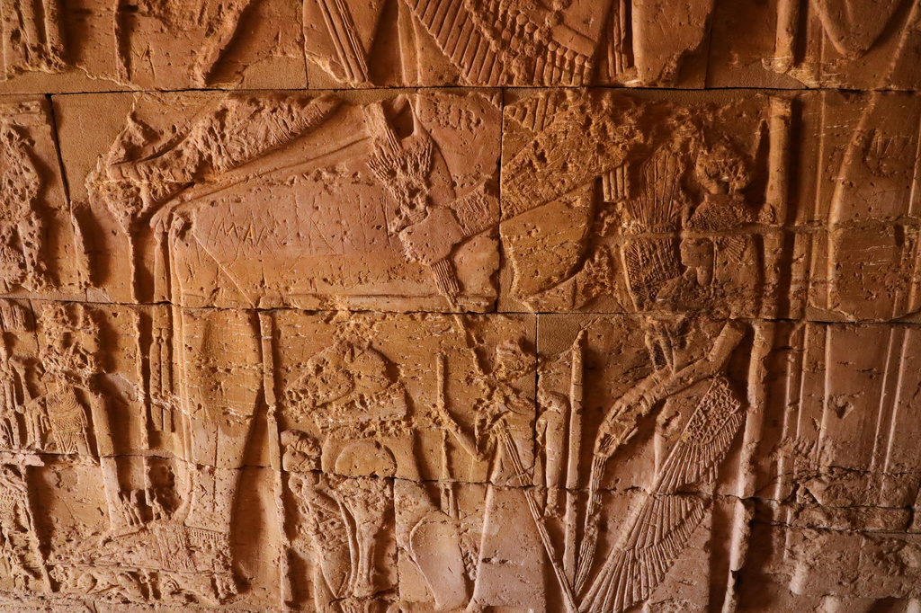 Ancient carved reliefs decorate the interior wall of a pyramid chapel at the Meroe archaeological site in Bejrawiya, Sudan, Saturday, Aug. 1, 2026. (AP Photo/Mohnd Blal)