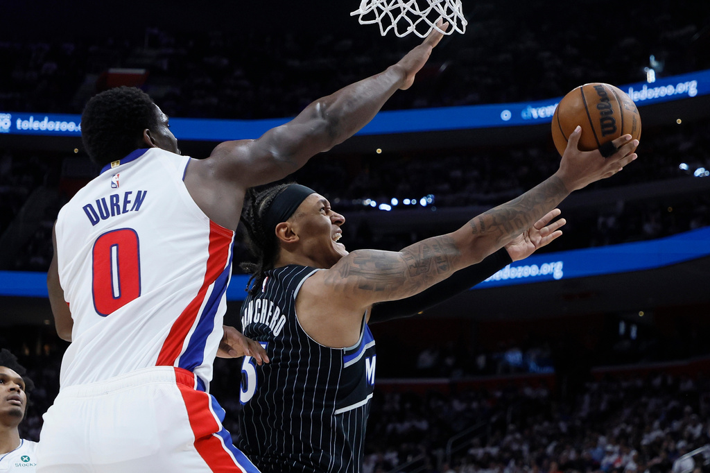 Orlando Magic forward Paolo Banchero (5) lays up a shot against Detroit Pistons center Jalen Duren (0) during the second half in Game 2 of a first-round NBA basketball playoffs series Wednesday, April 22, 2026, in Detroit. (AP Photo/Duane Burleson)