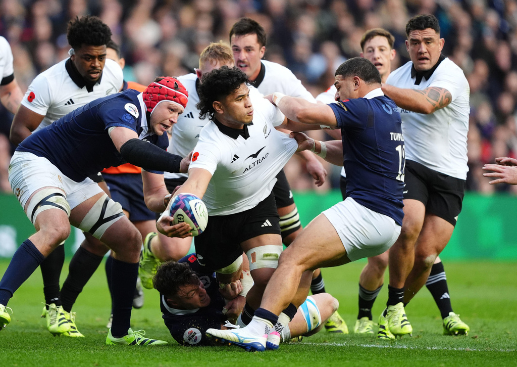 New Zealand's Wallace Sititi is tackled by Scotland's Sione Tuipulotu during Rugby Union Autumn Series match between Scotland and New Zealand in Edinburgh, Scotland, Saturday, Nov. 8, 2025. (Andrew Milligan/PA via AP)