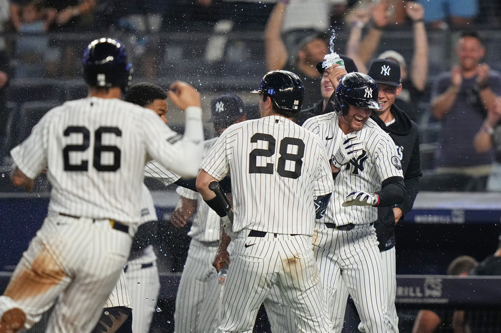 New York Yankees' Ryan McMahon, right, celebrates with teammates after a baseball game against the Atlanta Braves Saturday, Aug. 8, 2026, in New York. (AP Photo/Frank Franklin II)