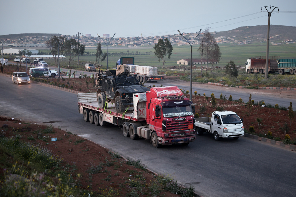 A U.S. military vehicle is transported on a truck as part of a convoy withdrawing from Qasrak base in northeastern Hasakah province toward the Jordanian border near Daraa, Syria, Thursday, April 16, 2026. (AP Photo/Ghaith Alsayed)
