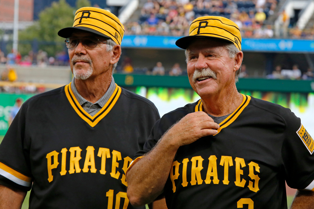 FILE - Tim Foli, left, and Phil Garner, the middle infield of the 1979 World Championship Pittsburgh Pirates team attend a pre-game ceremony remembering the team's accomplishment 40 years ago before a baseball game between the Pittsburgh Pirates and the Philadelphia Phillies in Pittsburgh, July 20, 2019. (AP Photo/Gene J. Puskar, File)
