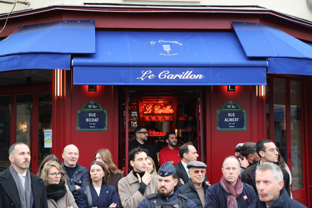 People gather outside "Le Carillon" before a tribute to victims Thursday Nov. 13, 2025 in Paris for ceremonies marking the 10th anniversary of terrorist attacks that killed 132 people and injured hundreds. (Ludovic Marin, Pool photo via AP)