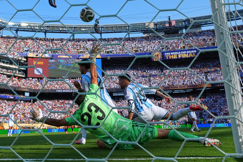 Spain's Ferran Torres (7) scores their first goal past Argentina goalkeeper Emiliano Martinez (23) during the World Cup final soccer match between Spain and Argentina in East Rutherford, N.J., near New York, Sunday, July 19, 2026. (AP Photo/Julio Cortez)