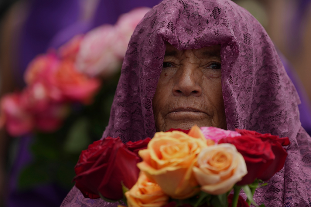 A penitents known as a "Veronica" takes part in the Jesus del Gran Poder procession in Quito, Ecuador, Friday, April 3, 2026. (AP Photo/Dolores Ochoa).
