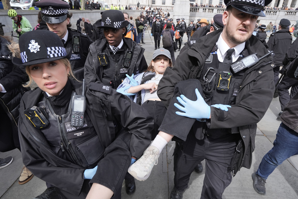Police remove a protester at a demonstration against the ban on Palestine Action, in Trafalgar Square, central London, Saturday April 11, 2026. (Stefan Rousseau/PA via AP)