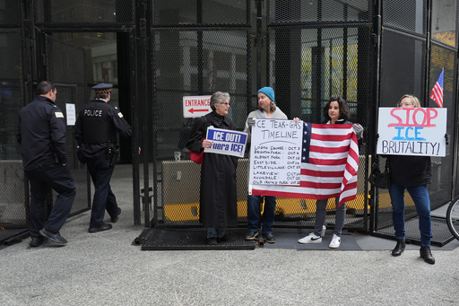 People hold signs as they wait for U.S. Customs and Border Patrol Gregory Bovino outside federal court in Chicago, Tuesday, Oct. 28, 2025. (AP Photo/Nam Y. Huh) People hold signs as they wait for U.S. Customs and Border Patrol Gregory Bovino outside federal court in Chicago, Tuesday, Oct. 28, 2025. (AP Photo/Nam Y. Huh)