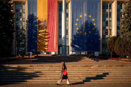 A woman walks in front of the government building, decorated with European Union and Moldovan flags, in Chisinau, Moldova, Friday, Sept. 26, 2025, ahead of parliamentary elections taking place on Sept. 28. (AP Photo/Vadim Ghirda) A woman walks in front of the government building, decorated with European Union and Moldovan flags, in Chisinau, Moldova, Friday, Sept. 26, 2025, ahead of parliamentary elections taking place on Sept. 28. (AP Photo/Vadim Ghirda)
