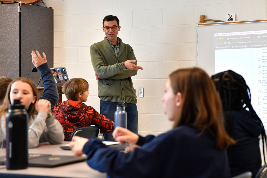 FILE - Teacher Donnie Piercey goes over the results of a writing assignment called "Find the Bot" during his class at Stonewall Elementary in Lexington, Ky., Feb. 6, 2023. (AP Photo/Timothy D. Easley, file)