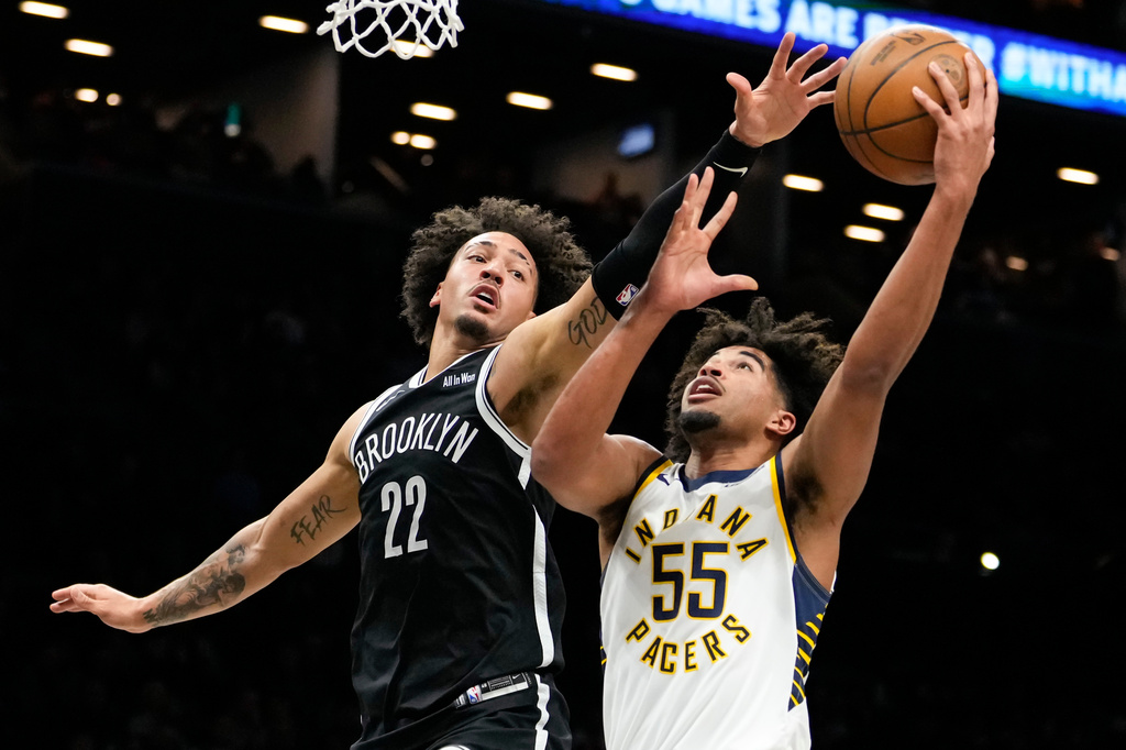 Indiana Pacers guard Ethan Thompson (55) shoots over Brooklyn Nets forward Jalen Wilson (22) during the first half of an NBA basketball game, Thursday, April 9, 2026, in New York. (AP Photo/Yuki Iwamura)