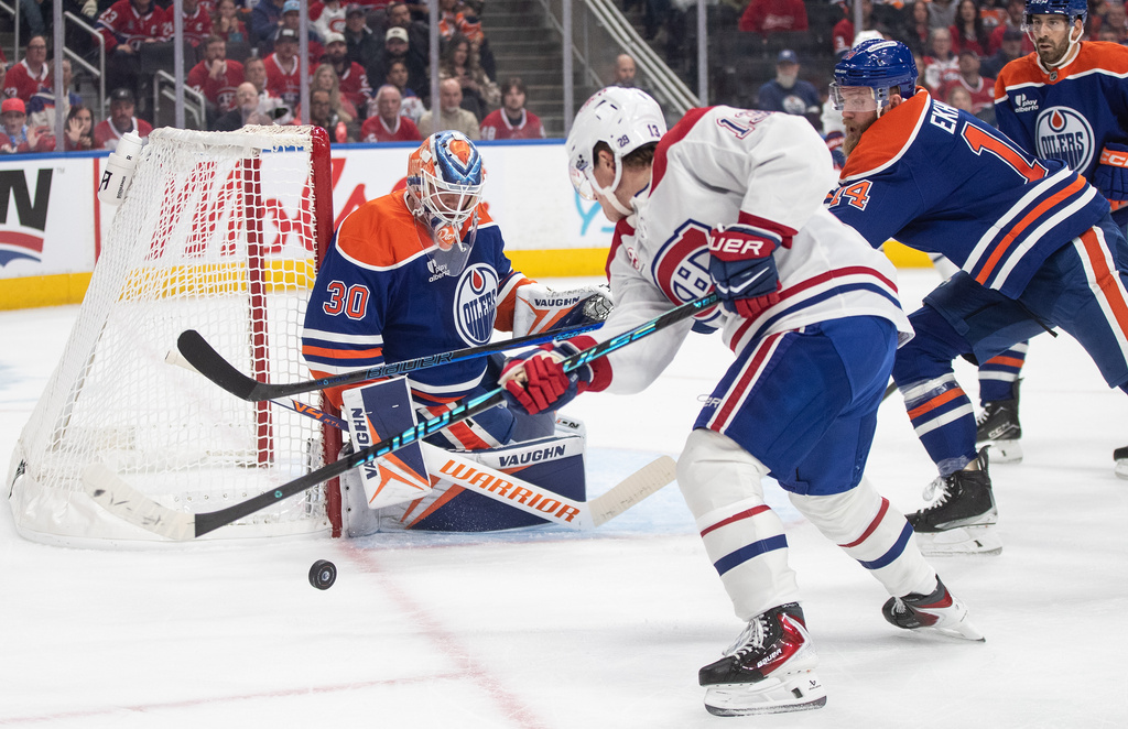 Montreal Canadiens' Cole Caufield (13) is stopped by Edmonton Oilers goalie Calvin Pickard (30) during first period NHL action, in Edmonton on Thursday, Oct. 23, 2025. (Jason Franson/The Canadian Press via AP)