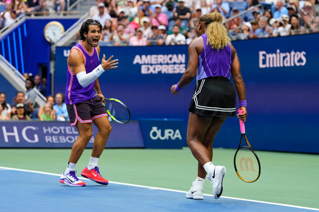 Carlos Alcaraz, of Spain, left, and Serena Williams, of the United States, react during a mixed doubles match at the U.S. Open tennis championships, Tuesday, Aug. 25, 2026, in New York. (AP Photo/Yuki Iwamura)