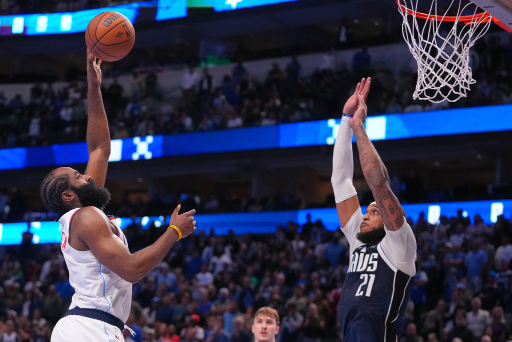 Los Angeles Clippers guard James Harden, left, goes up for a basket against Dallas Mavericks forward Daniel Gafford during overtime of an NBA Cup basketball game Friday, Nov. 14, 2025, in Dallas. (AP Photo/Julio Cortez)