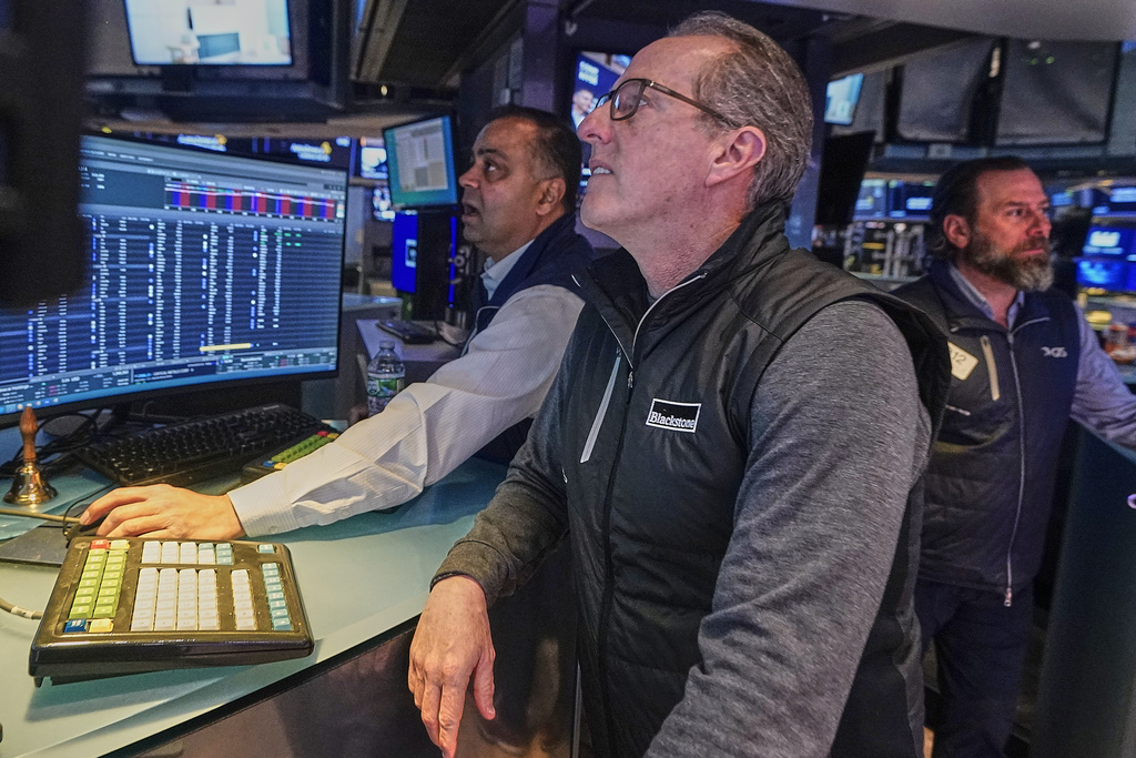 Specialists, from left, Dilip Patel, Glenn Carell, and Michael Pistillo work on the floor of the New York Stock Exchange, Monday, Feb. 2, 2026. (AP Photo/Richard Drew)