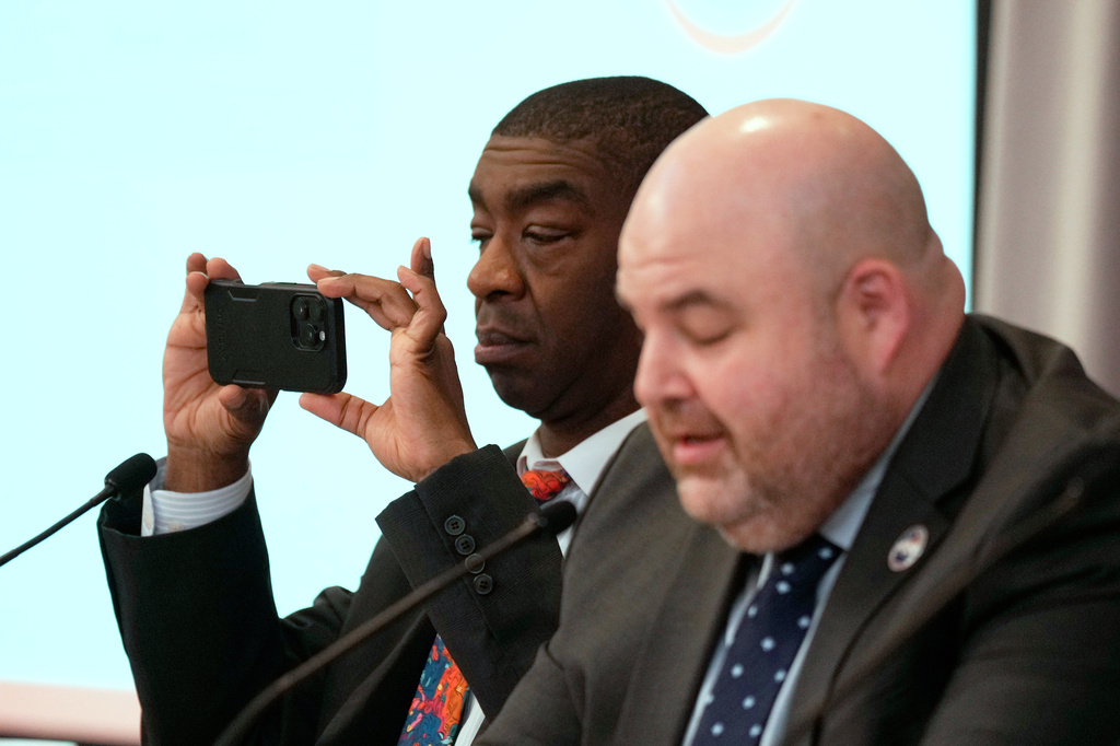 FILE - Commissioner Thomas Hicks takes a picture during the U.S. Election Assistance Commission Standards Board in-person public meeting, April 24, 2025, in Charlotte, N.C. (AP Photo/Chris Carlson, File)