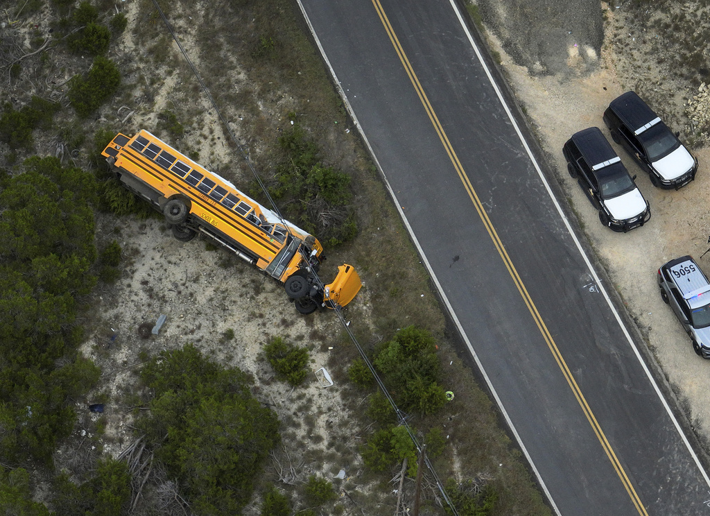 Police respond after a Leander Independent School District bus carrying students rollover crashed in Leander, Texas, Wednesday, Aug. 13, 2025. (Jay Janner/Austin American-Statesman via AP)