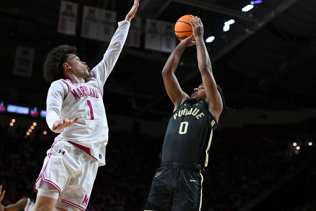 Purdue guard CJ Cox (0) looks to shoot over Maryland guard Darius Adams (1) during the first half of an NCAA college basketball game, Sunday, Feb. 1, 2026, in College Park, Md. (AP Photo/Terrance Williams)