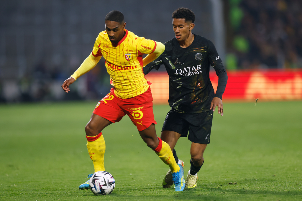 Lens' Wesley Said, left, challenges fro the ball with PSG's Senny Mayulu during the French League One soccer match between Lens and Paris Saint Germain, in Lens, northern France, Wednesday, May 13, 2026. (AP Photo/Jean-Francois Badias)