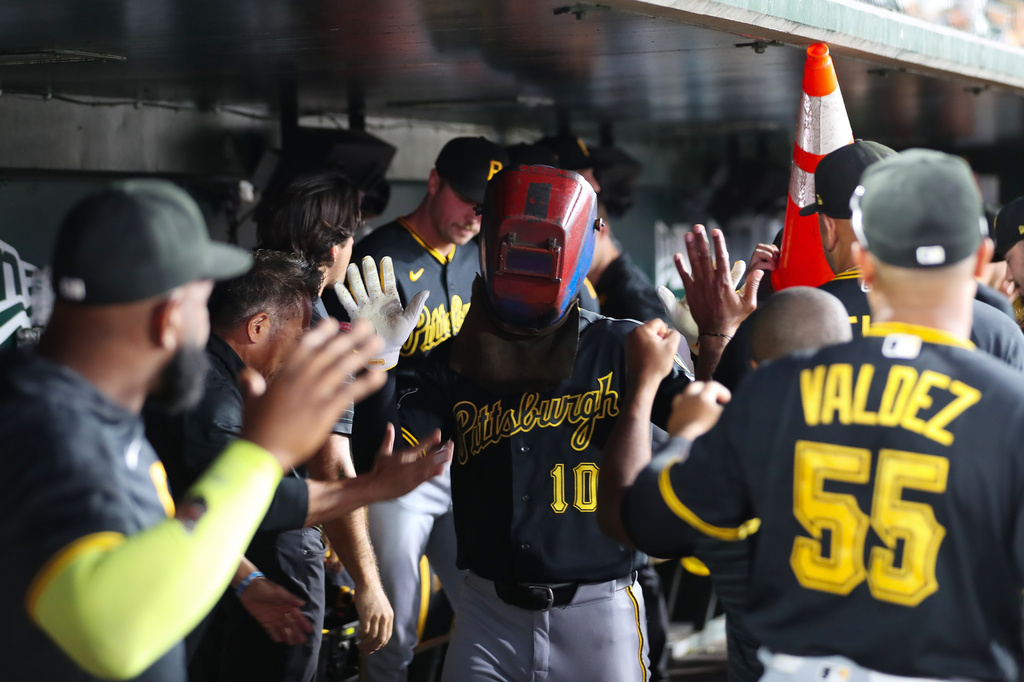 Pittsburgh Pirates' Bryan Reynolds (10) celebrates in the dugout with his teammates after hitting a two run during the seventh inning of a baseball game against the Athletics Tuesday, June 16, 2026, in West Sacramento, Calif. (AP Photo/Scott Marshall)