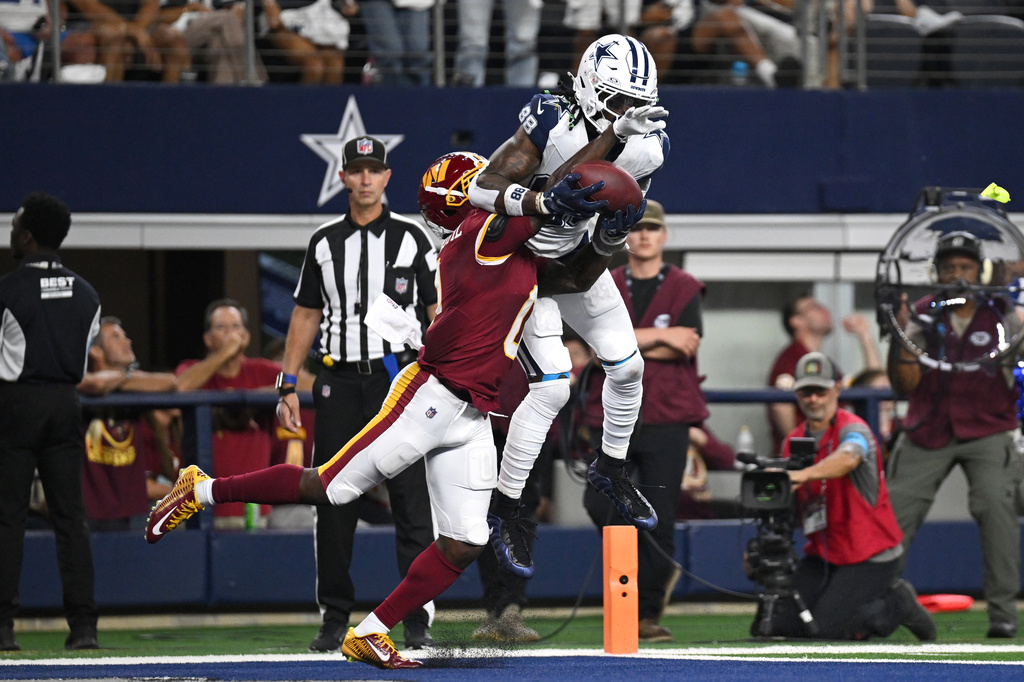 Dallas Cowboys wide receiver Ceedee Lamb (88) makes a catch to score a touchdown against Washington Commanders cornerback Mike Sainristil (0) in the second half during an NFL football game in Arlington, Texas, Sunday, Sept. 20, 2026. (AP Photo/Jessica Tobias)