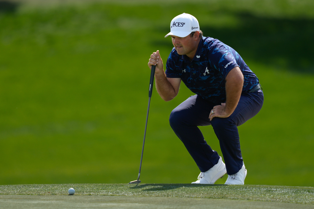 Patrick Reed of the United States lines up a putt on the first green during the third round of the Dubai Desert Classic in United Arab Emirates, Saturday, Jan. 24, 2026. (AP Photo/Altaf Qadri)