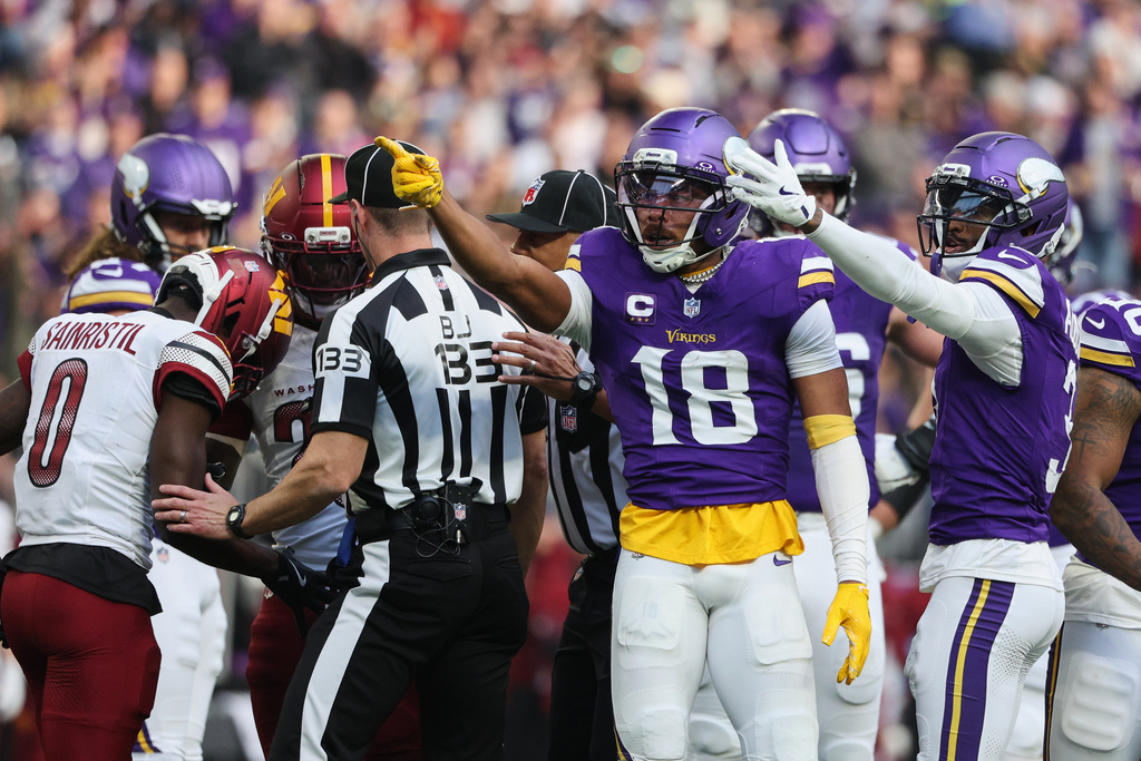 Minnesota Vikings wide receiver Justin Jefferson (18) reacts after a first down during the first half of an NFL football game against the Washington Commanders, Sunday, Dec. 7, 2025, in Minneapolis. (AP Photo/Matt Krohn)