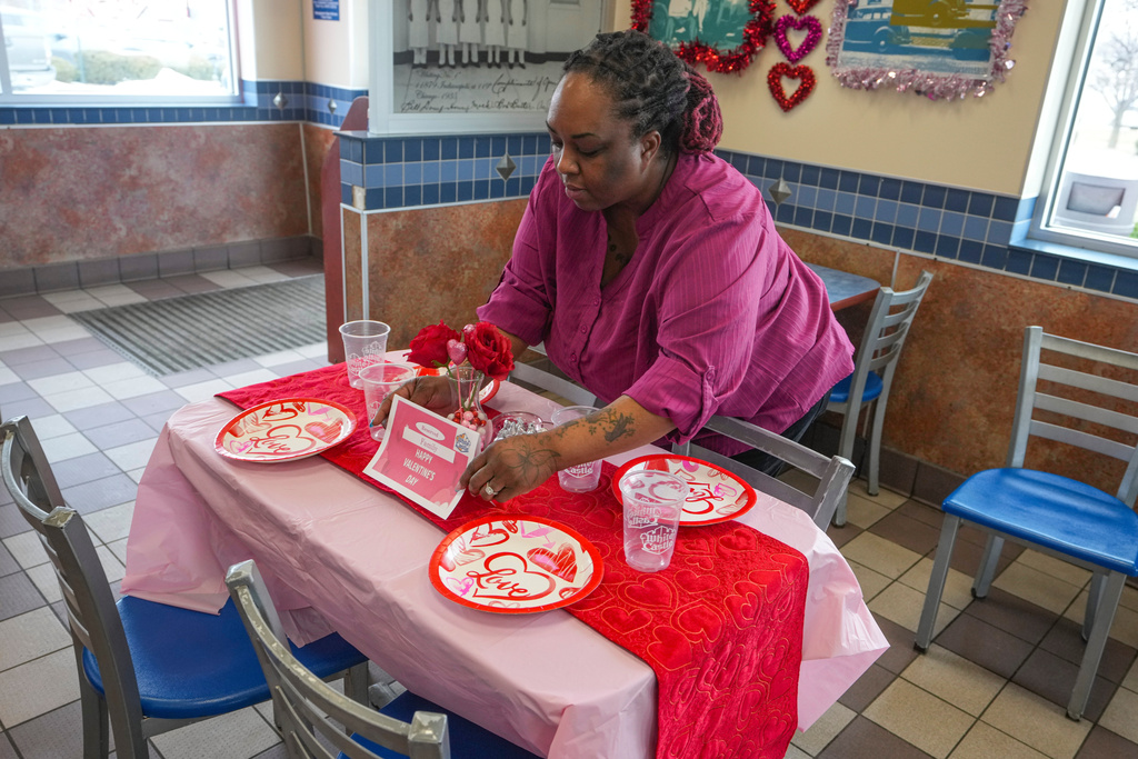 White Castle store manager Alisha Porter sets up a sample table that will be used for the store's Valentine's Day celebration in Indianapolis, Thursday, Feb. 12, 2026. (AP Photo/Michael Conroy)