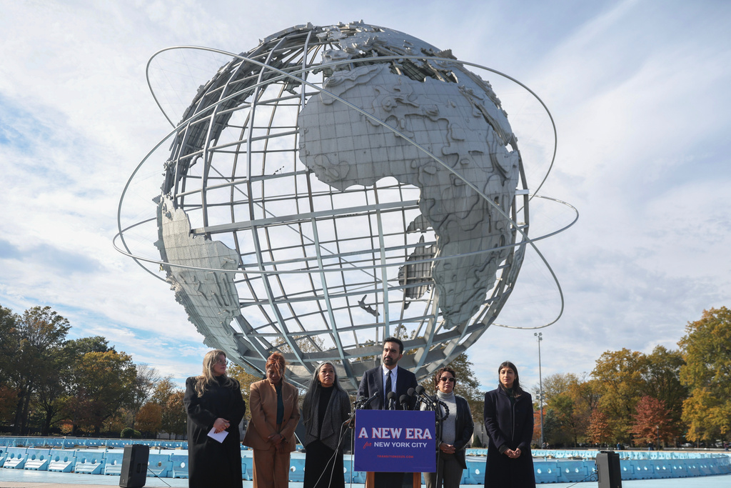 New York City mayor-elect Zohran Mamdani, center, speaks in front of the Unisphere alongside his transition team in the Queens borough of New York, Wednesday, Nov. 5, 2025. (AP Photo/Heather Khalifa)
