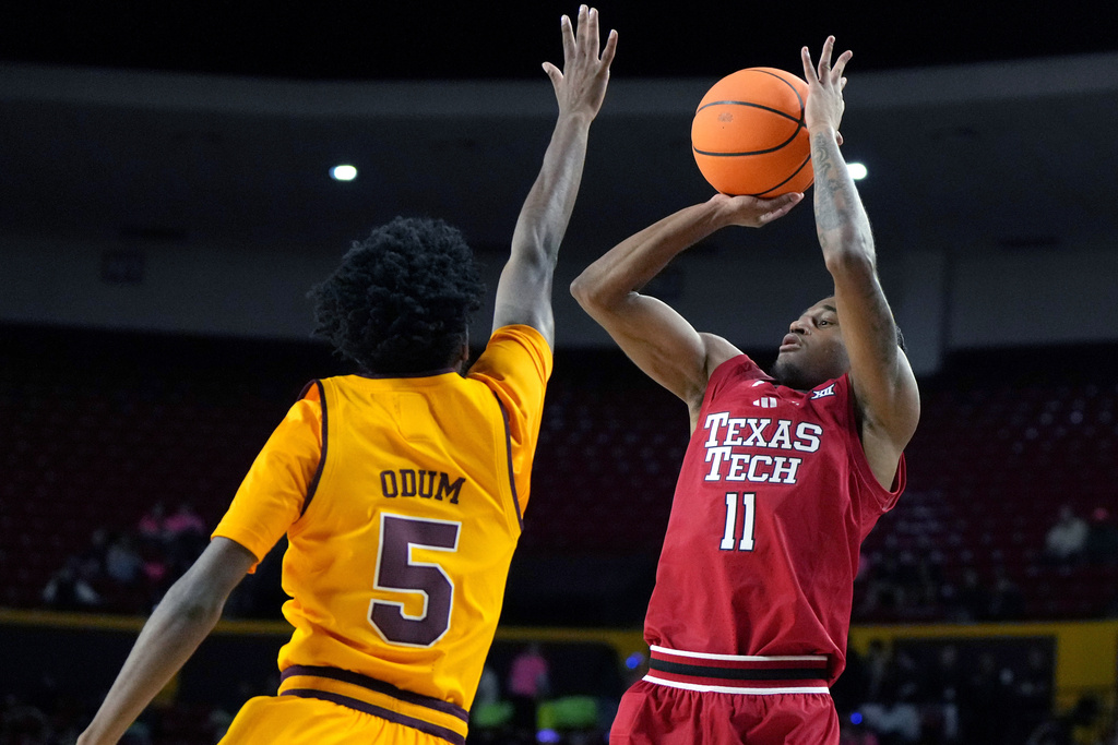 Texas Tech guard Jaylen Petty (11) shootsw over Arizona State guard Maurice Odum during the first half of an NCAA college basketball game, Tuesday, Feb. 17, 2026, in Tempe, Ariz. (AP Photo/Rick Scuteri)