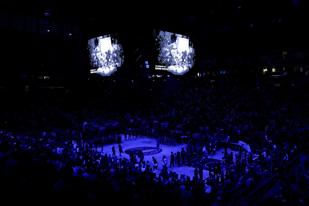 Minnesota Timberwolves and Cleveland Cavaliers players take part in a moment of silence for Renee Good, who was fatally shot by an ICE officer yesterday in Minneapolis, before an NBA basketball game, Thursday, Jan. 8, 2026, in Minneapolis. (AP Photo/Matt Krohn)