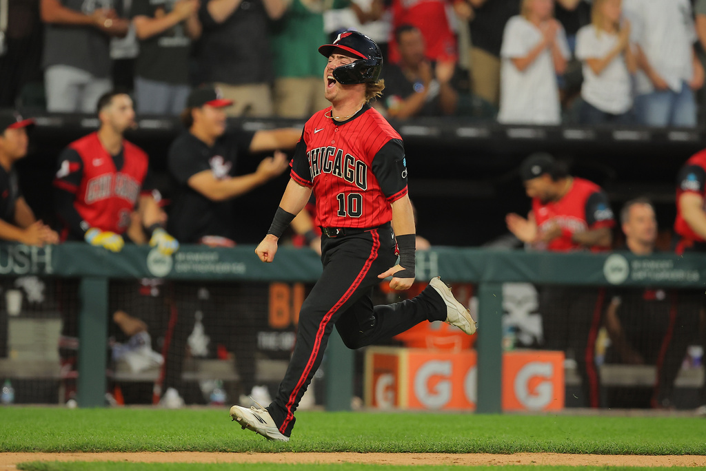 Chicago White Sox's Chase Meidroth scores on Tristan Peters two run RBI triple during the fifth inning of a baseball game against the Los Angeles Dodgers, Friday, June 12, 2026, in Chicago. (AP Photo/Melissa Tamez)