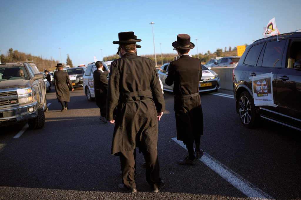 Ultra-Orthodox Jewish men block traffic between Jerusalem and Tel Aviv during a protest against military conscription, Wednesday, June 24, 2026. (AP Photo/Ohad Zwigenberg)