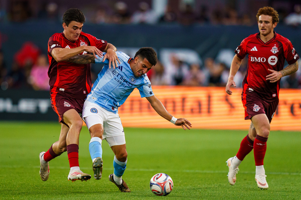 Toronto FC's Alonso Coello, left, vies for the ball with New York City FC's Nicolas Fernandez, second from left, during the first half of an MLS soccer match in Toronto, Saturday, Aug. 29, 2026. (Keito Newman/The Canadian Press via AP)