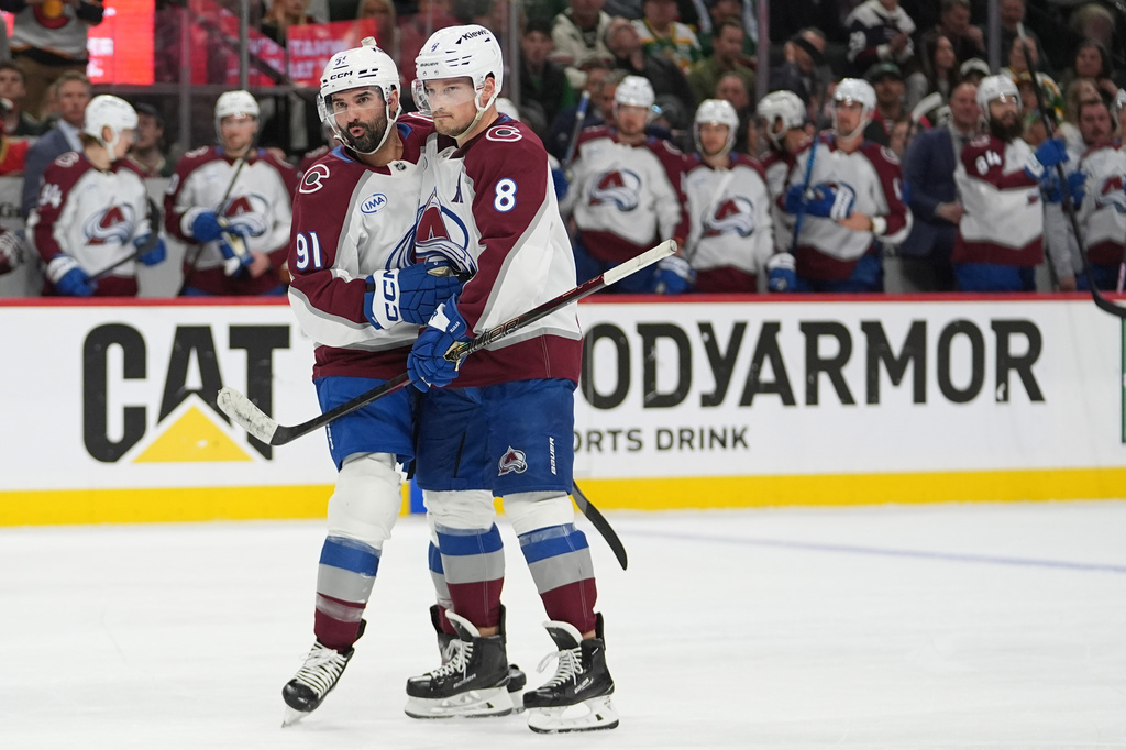 Colorado Avalanche center Nazem Kadri (91) celebrates with defenseman Cale Makar (8) after scoring a goal during the second period of Game 4 in an NHL Stanley Cup hockey second-round playoff series against the Minnesota Wild Monday, May 11, 2026, in St. Paul, Minn. (AP Photo/Abbie Parr)