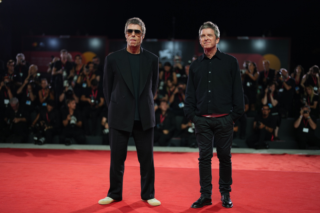 Liam Gallagher, left, and Noel Gallagher pose for photographers at the red carpet for the film 'Oasis: Don't Look Back In Anger' during the 83rd edition of the Venice Film Festival in Venice, Italy, on Saturday, Sept. 5, 2026. (Photo by Scott A Garfitt/Invision/AP)
