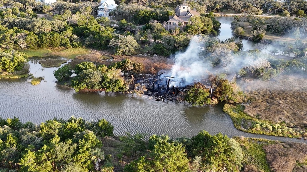 In this aerial view image taken from video from WCBD, smoke rises from a house fire on Edisto Island, S.C., on Oct. 4, 2025. (WCBD via AP)