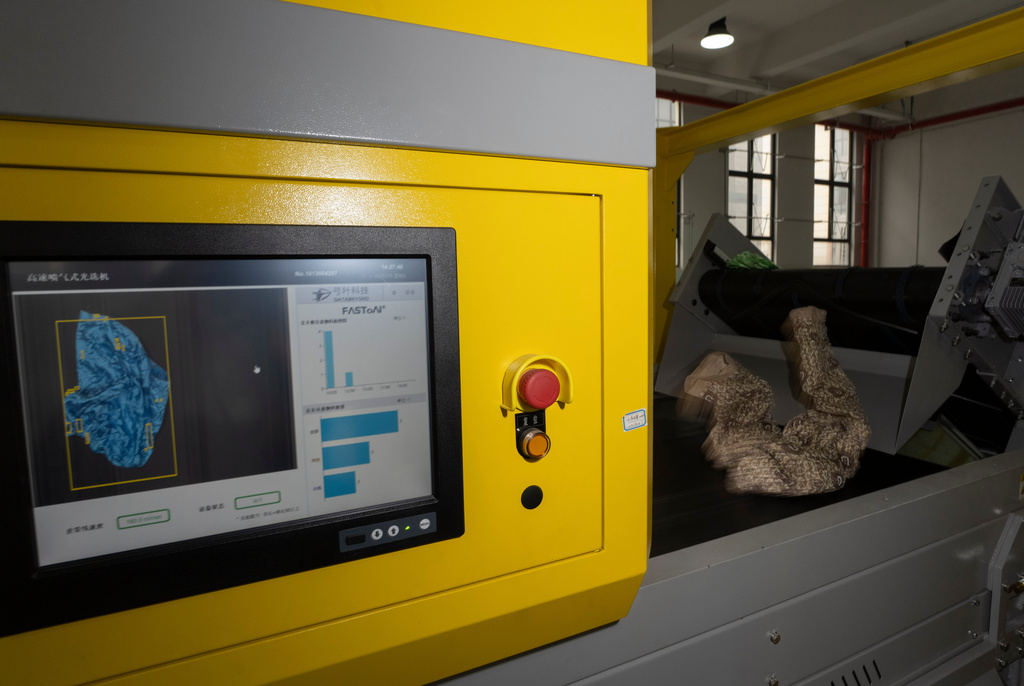 Databeyond's Fastsort-Textile AI sorting machine process synthetic textile at high speed at a textile sorting facility in Zhangjiagang in eastern China's Jiangsu province on March 20, 2026. (AP Photo/Ng Han Guan)