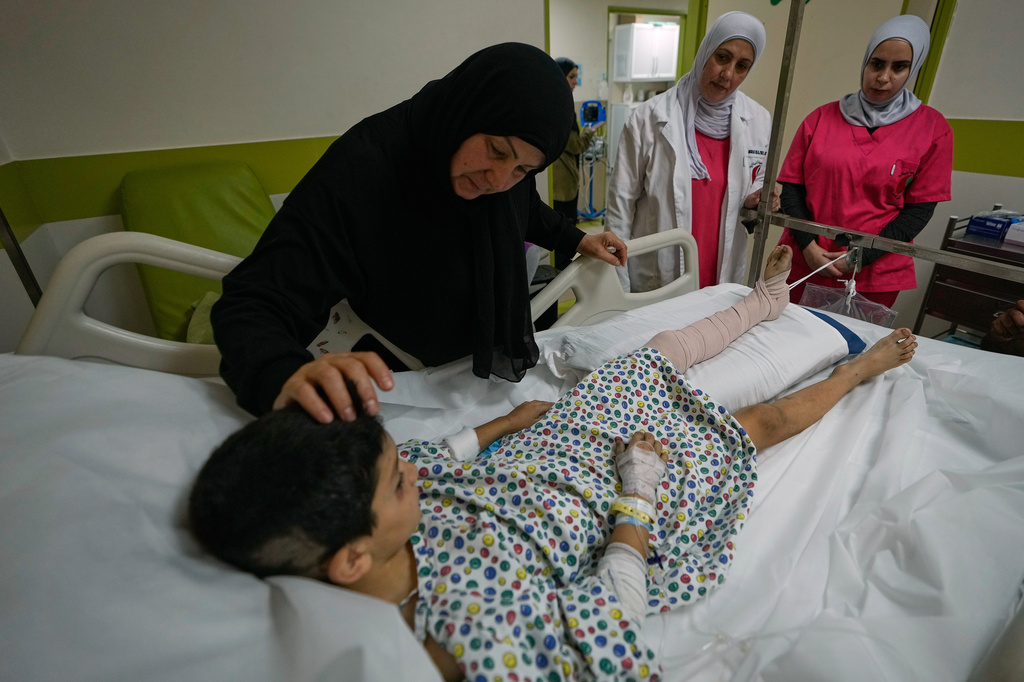 Mustafa Farhat, 8, who was injured in an Israeli airstrike that hit his home and killed his parents, is comforted by his grandmother at a hospital in the town of Nabatiyeh, southern Lebanon, Monday, Sept. 7, 2026. (AP Photo/Mohammed Zaatari)