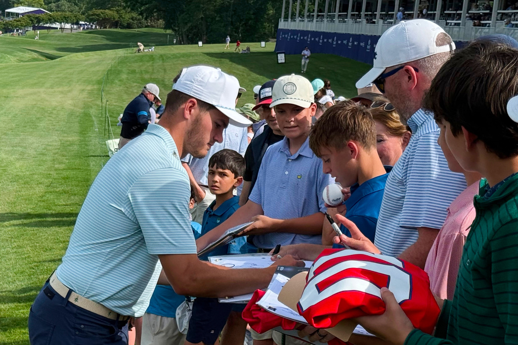 New England Patriots quarterback Drake Maye signs autographs for fans after the pro-am at the Trust Championship golf tournament, Wednesday, May 6, 2026, at Quail Hollow Club in Charlotte. (AP Photo/Steve Reed)