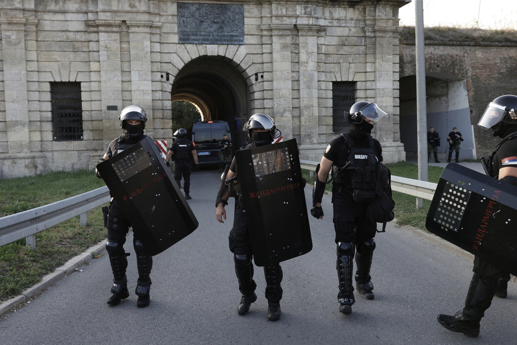 Serbian gendarmerie officers take positions on a street to separate anti-government protesters and supporters of Serbian President Aleksandar Vucic in Novi Sad, Serbia, Saturday, Sept. 13, 2025. (AP Photo/Marko Drobnjakovic)