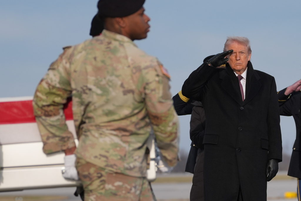 President Donald Trump salutes as a Army carry team moves the flag-draped transfer case with the remains of Iowa National Guard soldier Sgt. Edgar Brian Torres-Tovar, 25, of Des Moines, Iowa, during a casualty return, Wednesday, Dec. 17, 2025, at Dover Air Force Base, Del. (AP Photo/Evan Vucci)
