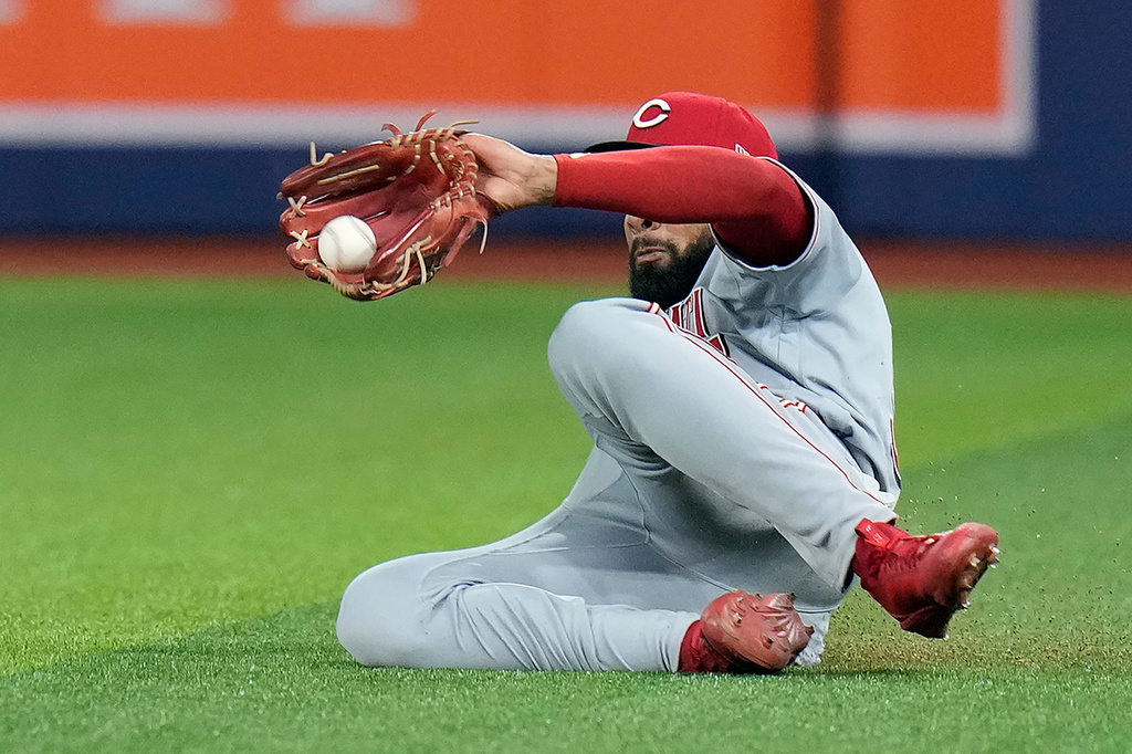 Cincinnati Reds right fielder Rece Hinds makes a sliging catch on a fly out by Tampa Bay Rays' Richie Palacios during the fourth inning of a baseball game Monday, April 20, 2026, in St. Petersburg, Fla. (AP Photo/Chris O'Meara)