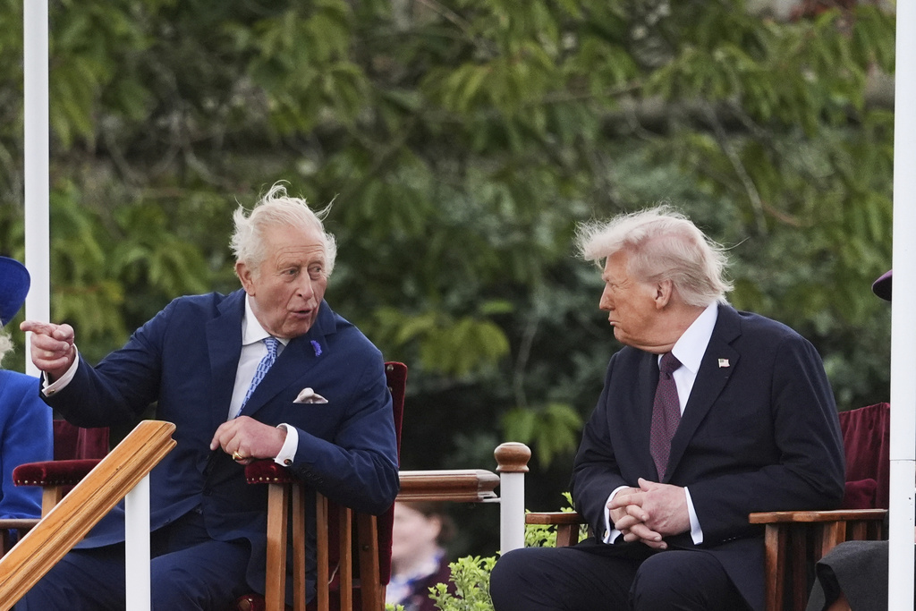 President Donald Trump, right, speaks with Britain's King Charles III as they attend a Beating Retreat musical performance on the East Lawn of Windsor Castle, in Windsor, England, Wednesday, Sept. 17, 2025. (AP Photo/Evan Vucci)