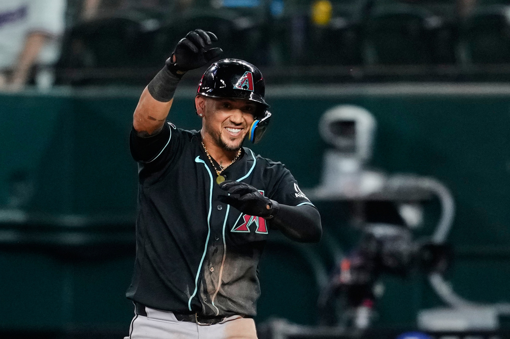 Arizona Diamondbacks' Ildemaro Vargas celebrates his two-run single in the ninth inning of a baseball game against the Texas Rangers Wednesday, May 13, 2026, in Arlington, Texas. (AP Photo/Tony Gutierrez)