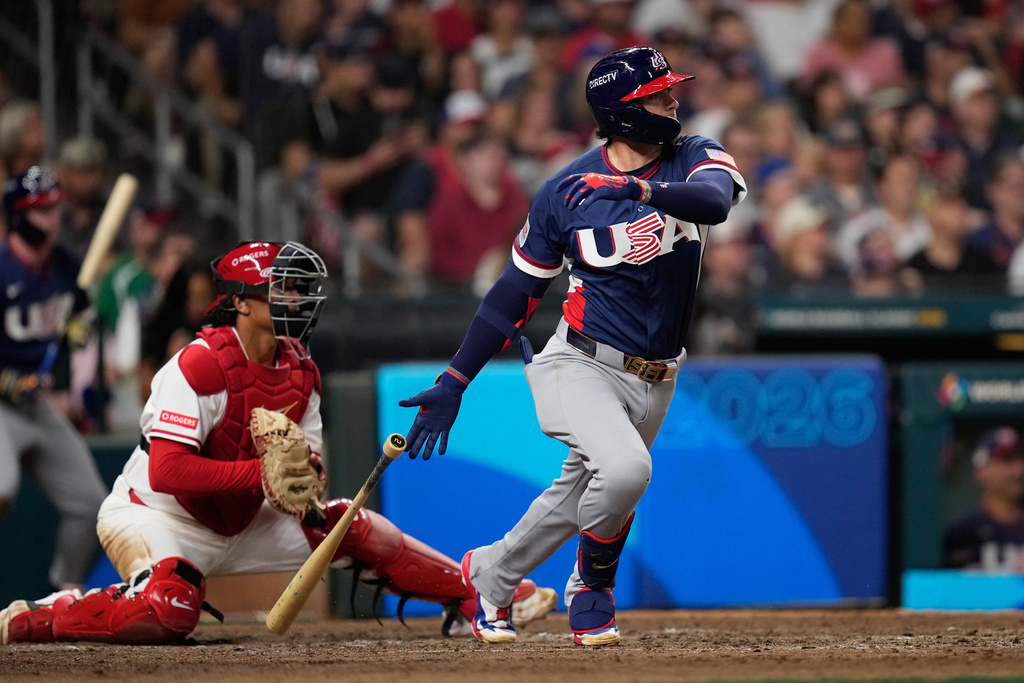United States second baseman Brice Turang (13) hits an RBI single against Canada during the sixth inning of a World Baseball Classic quarterfinal game, Friday, March 13, 2026, in Houston. (AP Photo/David J. Phillip)